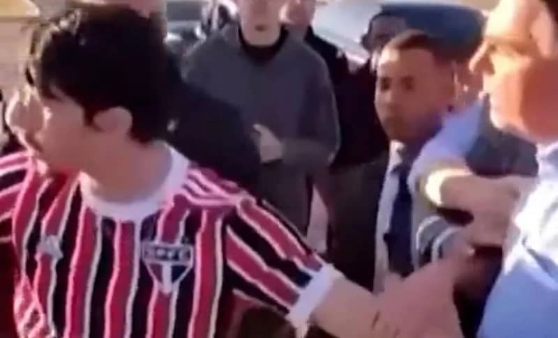 شاهد .. رئيس البرازيل يمسك شابًا من قميصه محاولاً انتزاع هاتفه